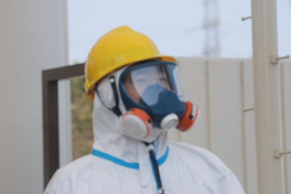 One of the gate guards in a hazmat suit, helmet and dual intake respirator